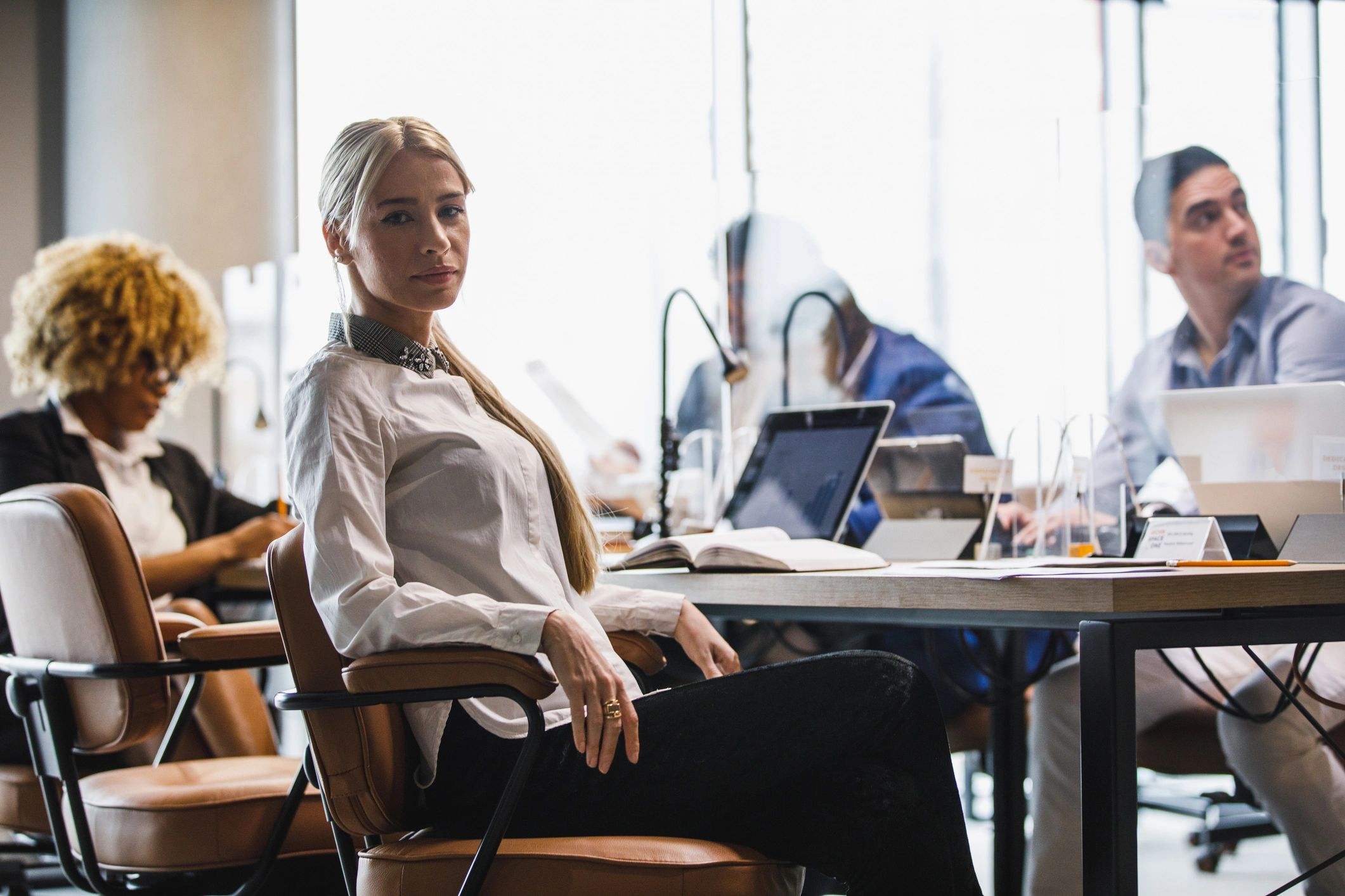 Professional bookkeeper smiling in a modern office workspace